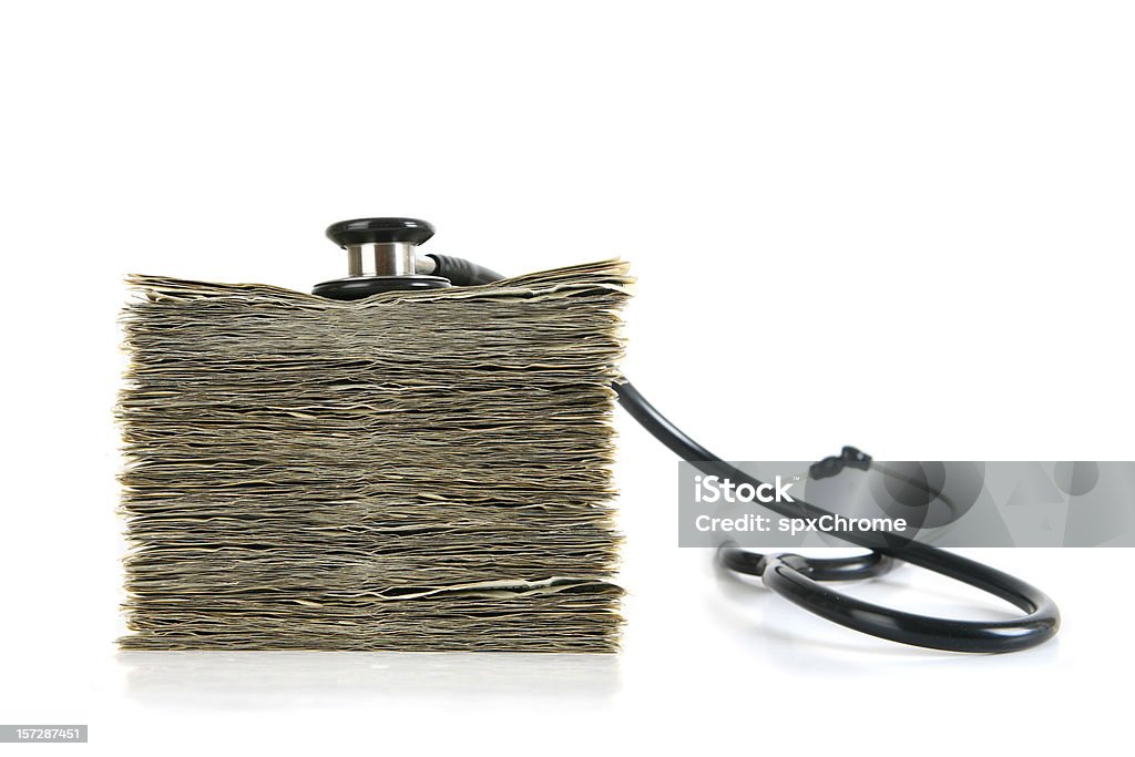 High Cost of Healthcare Stethoscope on top of large stack of cash. Healthcare And Medicine Stock Photo