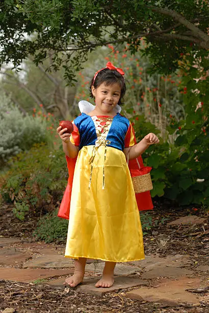 Little Snowhite in the forest holding apple