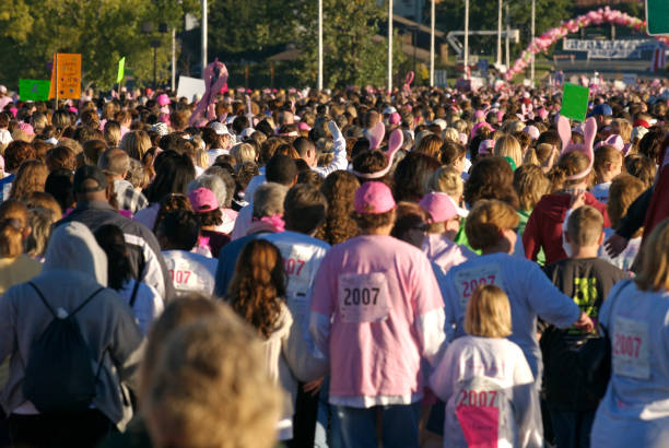 Race for the Cure Some of the 26,000 women who participate in the Susan G. Komen Race for the Cure in Little Rock, Arkansas, to raise money to fight breast cancer. walking for a cause stock pictures, royalty-free photos & images
