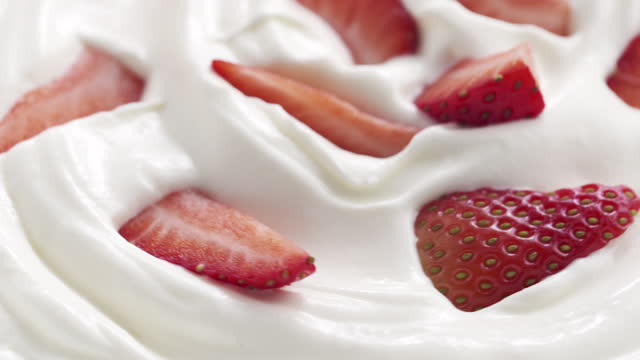 fresh sliced straberries in cream rotating background loopable