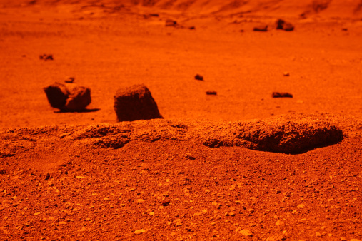 Shot of volcanic rock w/ orange filter. Appears interplanetary.