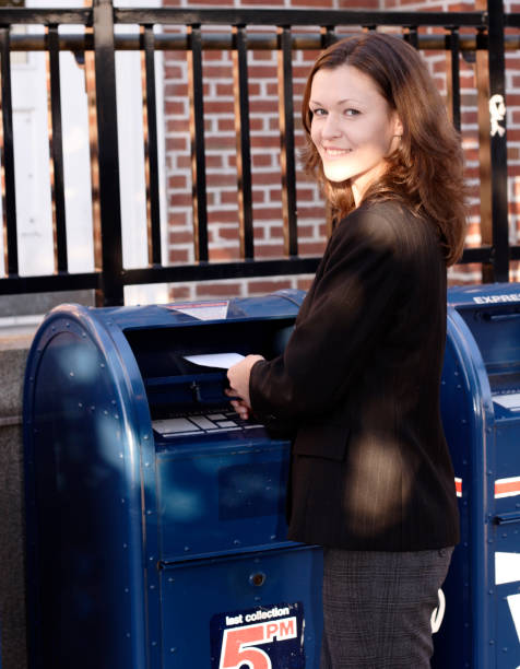 istock Young Woman Mails a Letter 157288456