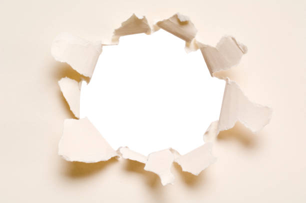 istock Ripped hole in a paper, isolated 157288597
