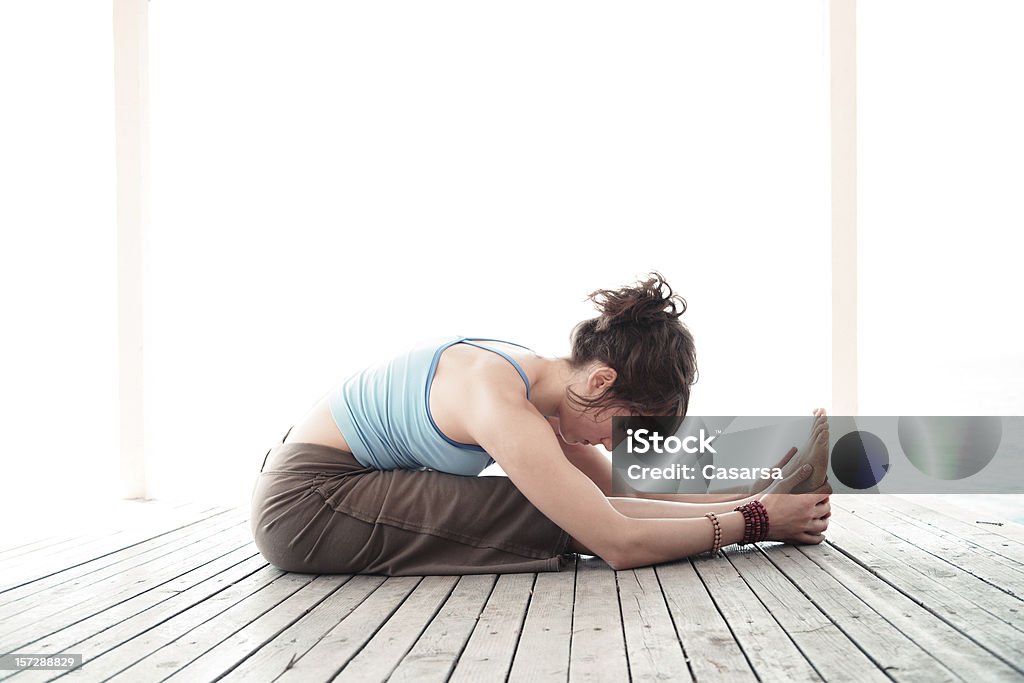 Yoga - Paschimottanasana Young girl practicing yoga 20-24 Years Stock Photo