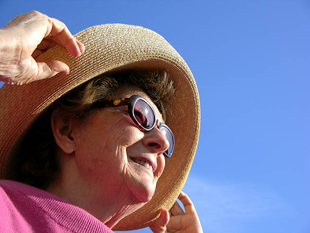 Woman looking into sun stock photo