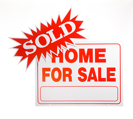 A home for sale sign with a sold burst attached.  White background.