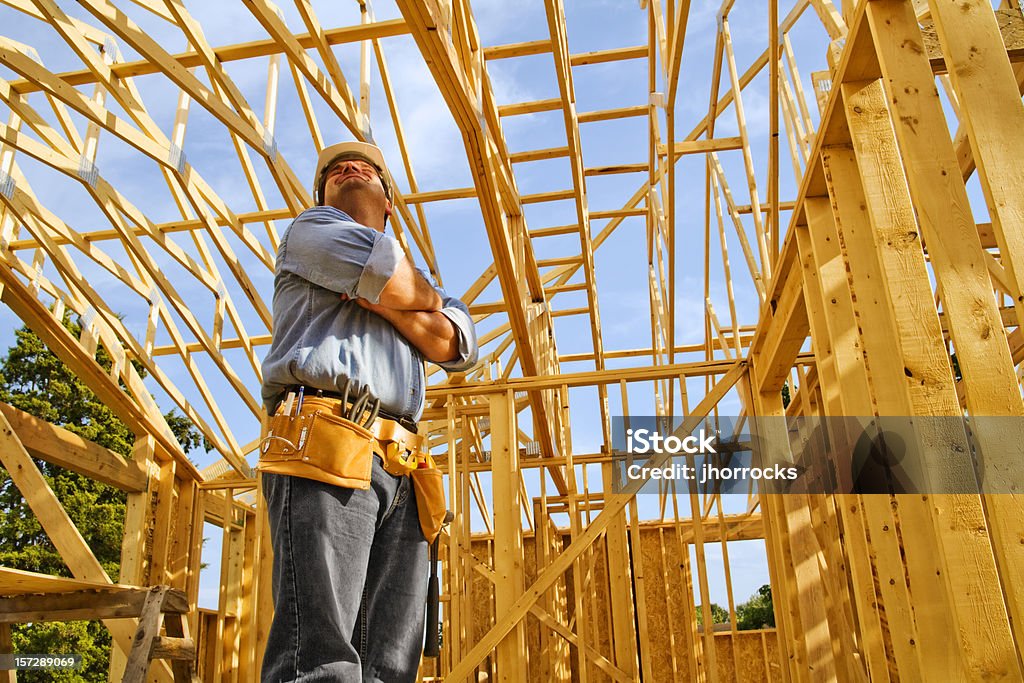 Construction Worker Pausing to Admire Handiwork Photo of a construction worker pausing to check out his handiwork. Architect Stock Photo