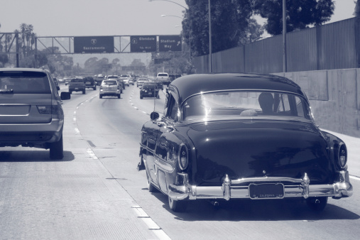 A restored classic car cruising the freeways of Los Angeles.