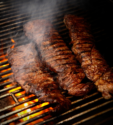 Grilled ribeye steaks on the grill. Close-up. Macro. American cuisine.