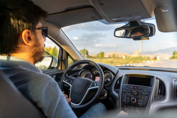 Male model driving a car. Man on a road trip.