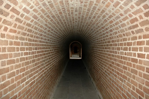 Diminishing perspective through a brick tunnel in the belly of Fort Clinch on Amelia Island, Florida.  Fort Clinch predates the American Civil War and was occupied by both Union and Confederate soldiers during the war.