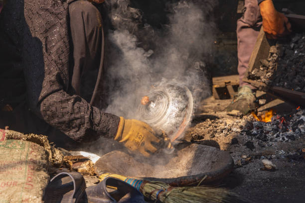 Sokalipura, Srinagar, Jammu and Kashmir, India. October 25, 2022. Man making copper and tin ware at a market in Srinagar.