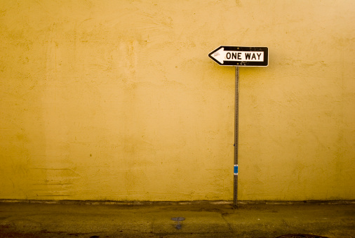 One way sign in an alley.
