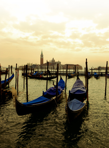 Photo of traditional gondolas on canal in Venice, Italy