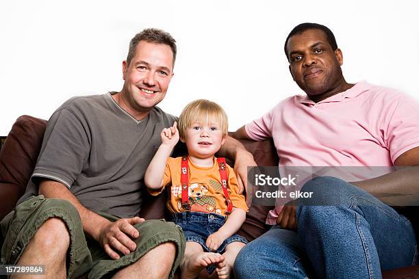 Foto de Unconventional Multirracial Família Dois Homens Garoto Sentado No Sofá e mais fotos de stock de Criança