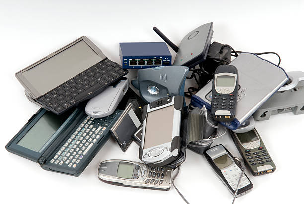 Pile of discarded computers and phones stock photo