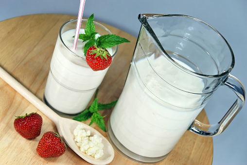 Delicious kefir drink with strawberries, mint leaf and grains of kefir