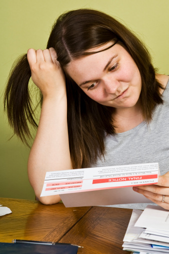A young mother looking at a final notice statement.