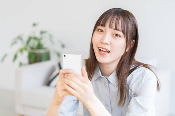 istock attractive Asian woman using a smart phone 1572902701
