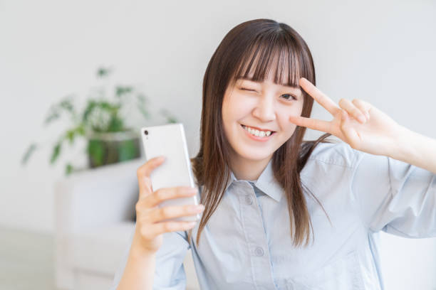 istock attractive Asian woman using a smart phone 1572903211