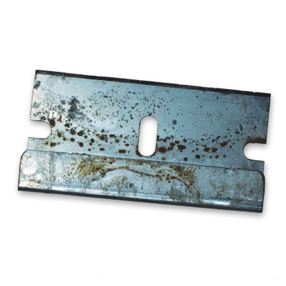 one old rusty brown door hinge lies on a gray table