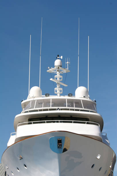 the upper part is the roof of a luxurious white yacht against a cloudy sky