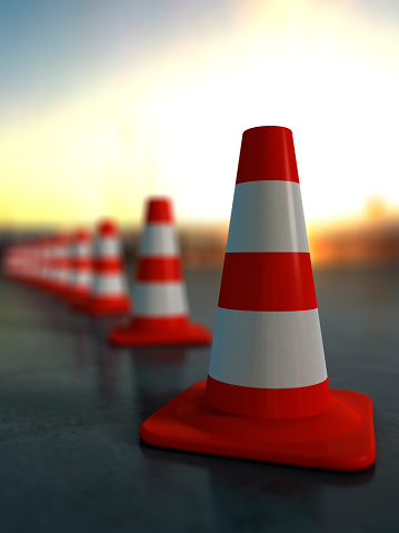 Brightly coloured traffic cones on polished concrete. 3D render with HDRI lighting and raytraced textures.