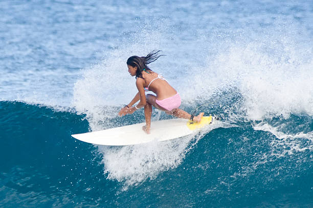 Young woman surfing a wave