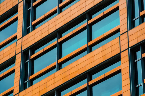 Modern exterior building glass window with orange color patterns, for industrial, architectural and residential purposes.