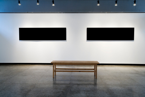 Exhibition wall of an art gallery with two black frames. Concepts: art, museum; culture, space; exhibition, design, creativity.