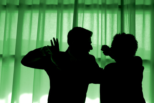 Two men fighting. Silhouttes.