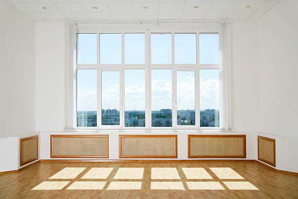 Sunlit Modern Interior Interior of a modern studio with sunlit big window. wide window stock pictures, royalty-free photos & images
