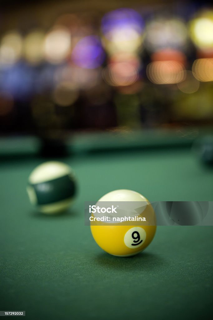 Billiards 9 Ball number nine over a Billard table. Arcade room atmosphere. Pool Table Stock Photo