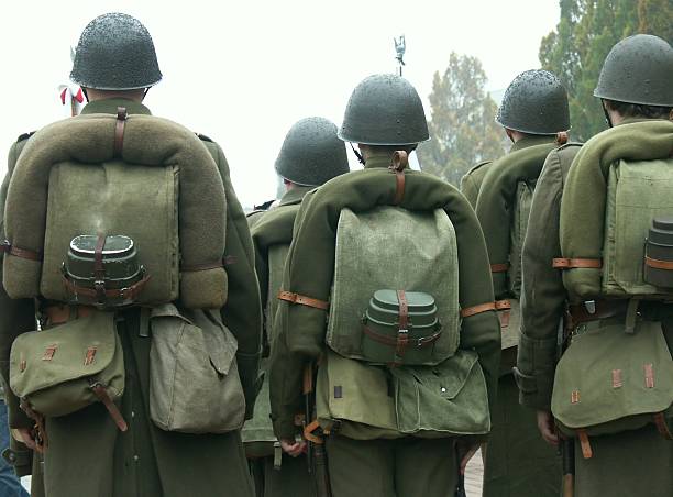 istock Group of soldiers from the back in a cluster 157292129