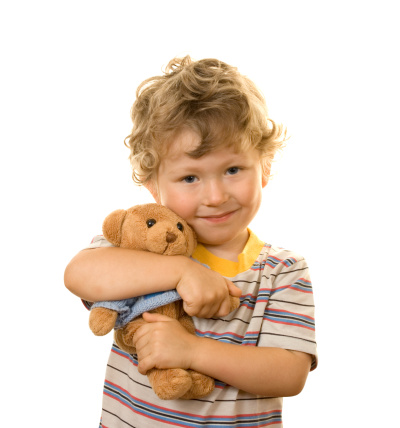 portrait of smal boy with teddy bear isolated on white