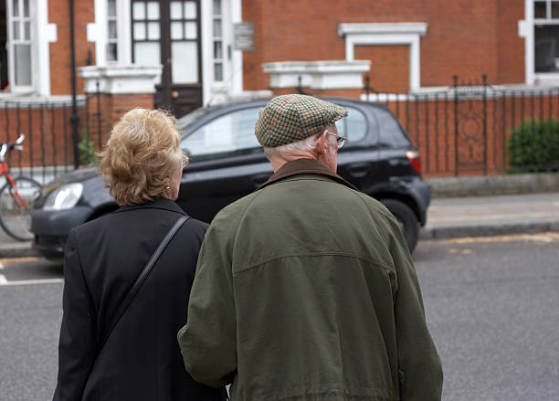 istock Elderly couple crossing the road 157292159