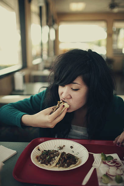 istock Hipster Asian Girl Eating a Taco 157292259