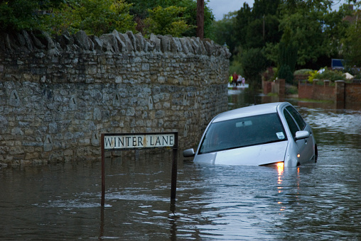 car drives into verge in 3 ft of water, 43mm of rain in one day, 20th July 2007, Oxfordshire, England.