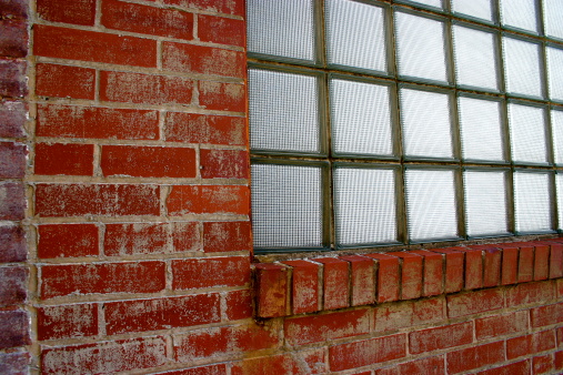 An old brick and glass block wall.