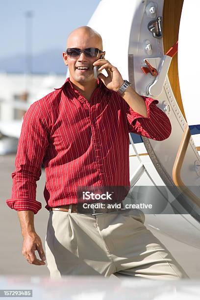 Affluent Travelcasual Businessman On Phone By Private Jet Stock Photo - Download Image Now