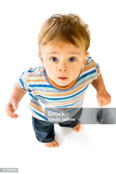 Linda Little Boy Looking Up At Camera On White Foto de stock y más banco de imágenes de Niño - Niño, Vista elevada, Foto de estudio