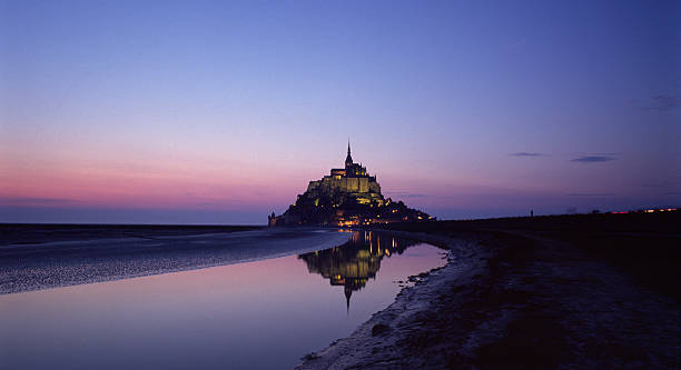 Photograph of Mont Saint Michel at dusk stock photo