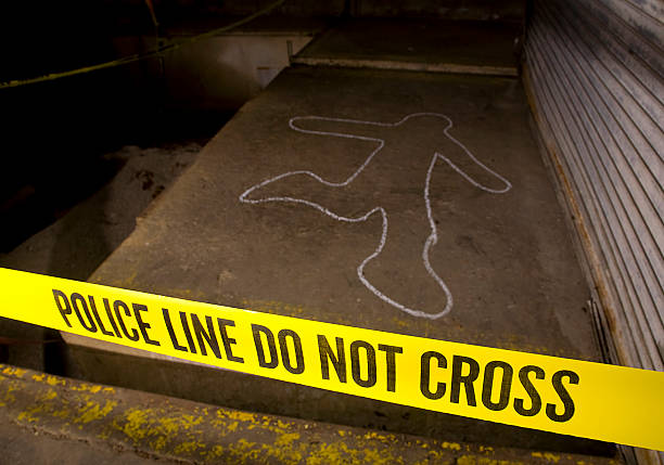 Police Line Crime Scene A crime scene with a chalk drawing and yellow "POLICE LINE" tape. chalk outline stock pictures, royalty-free photos & images