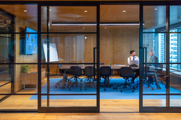 istock Business people working in a board room with a laptop and presentation 1572942772