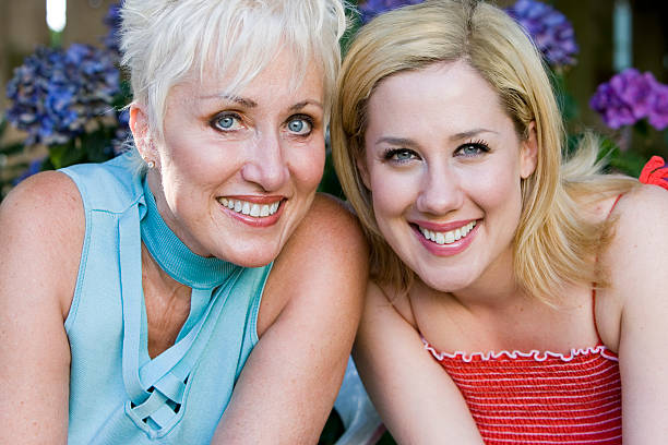 Beautiful Blond Mom and Daughter Portrait Outside at Camera  grandmother real people front view head and shoulders stock pictures, royalty-free photos & images