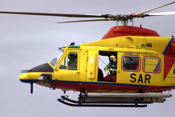 istock Search and Rescue Helicopter with winch man 157294360