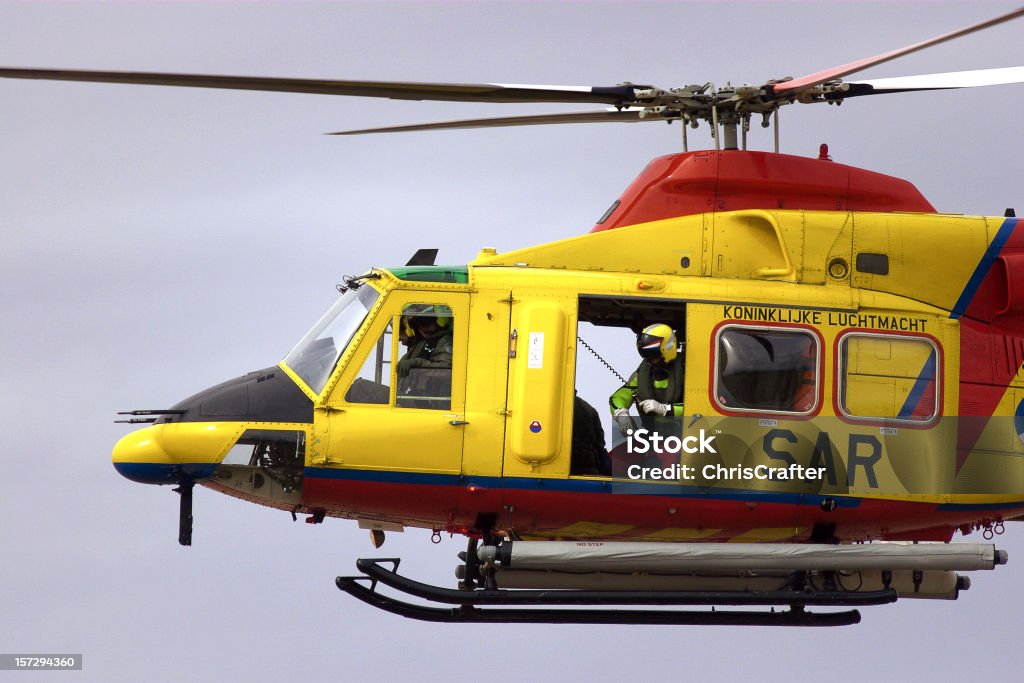 Search and Rescue Helicopter with winch man  Charity and Relief Work Stock Photo