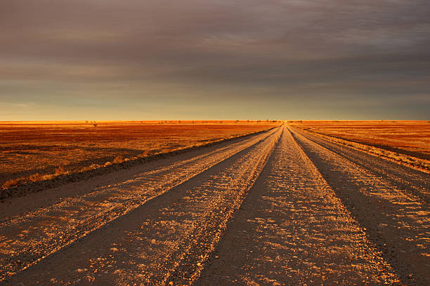 закат track - desert road desert road landscape стоковые фото и изображения