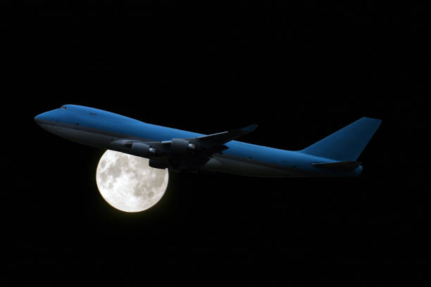 istock Airplane at midnight, in front of full moon 157294632