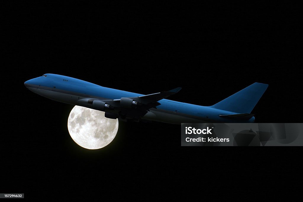 Airplane at midnight, in front of full moon An airplane at night, the full moon in the background. Airplane Stock Photo
